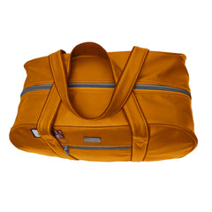 A mustard-yellow or golden-orange duffel bag is pictured.